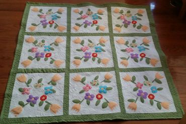 Wall hanging or lap quilt. Quilted floral applique wreaths.
