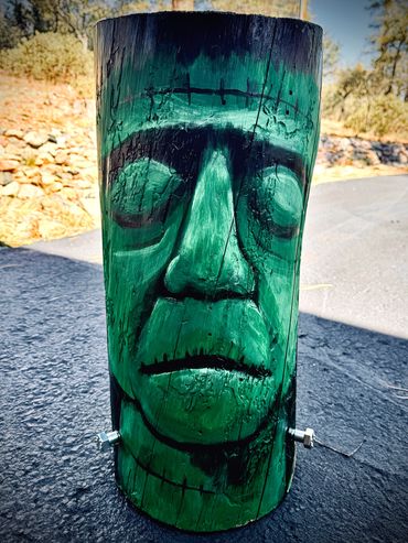 Wood log painted as Frankenstein.