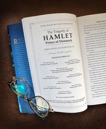 Open book with a pair of glasses.
