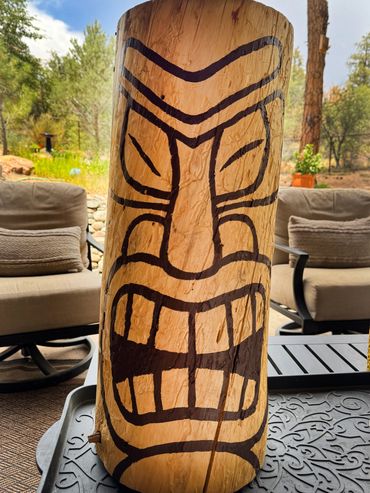 Wood log painted tiki face.