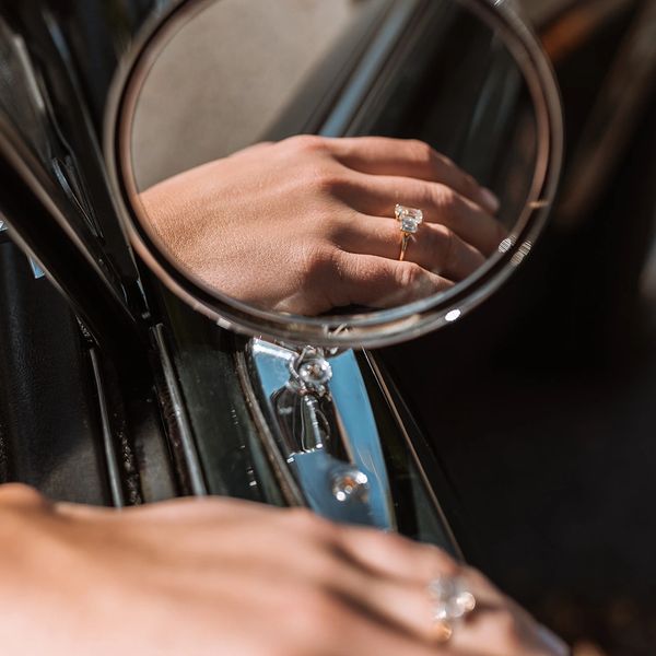 a emerald shape wedding ring in a mirror