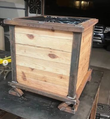 A wooden planter box with metal frame details.
