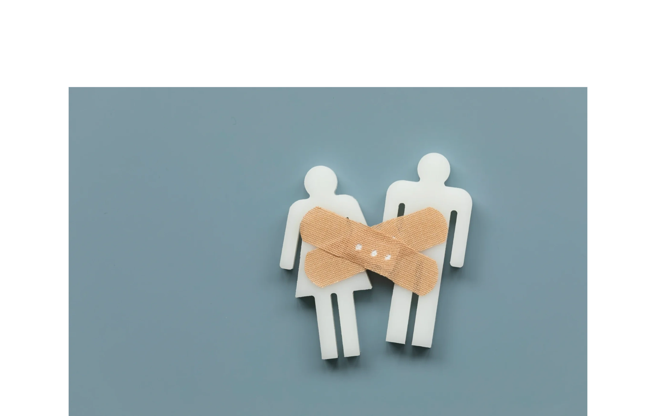 Paper cutout couple connected by a bandage, symbolizing couples therapy and relationship repair.
