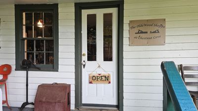 A rustic wooden shop entrance with an open sign.