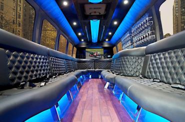 Luxurious limousine interior with blue lighting.
