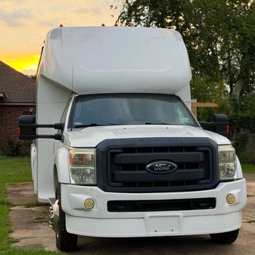 White Ford Super Duty truck at sunset.