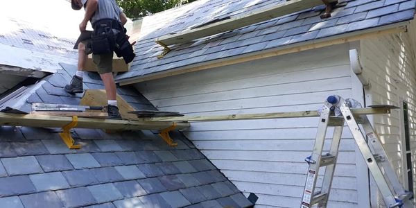 Roofer installing slate