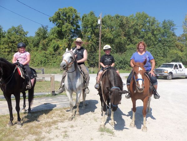 People riding horses outdoors.