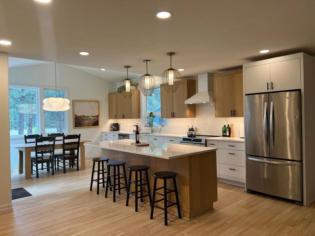 Spacious modern kitchen with island and dining area.