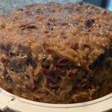A moist, dense cake covered in a caramelized coconut pecan frosting.
