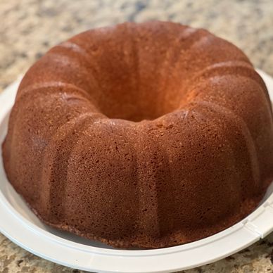 A freshly baked bundt cake on a white plate.