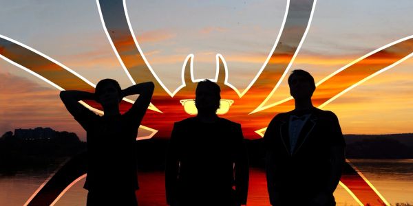 Silhouettes of three people with a spider drawing and sunset background.