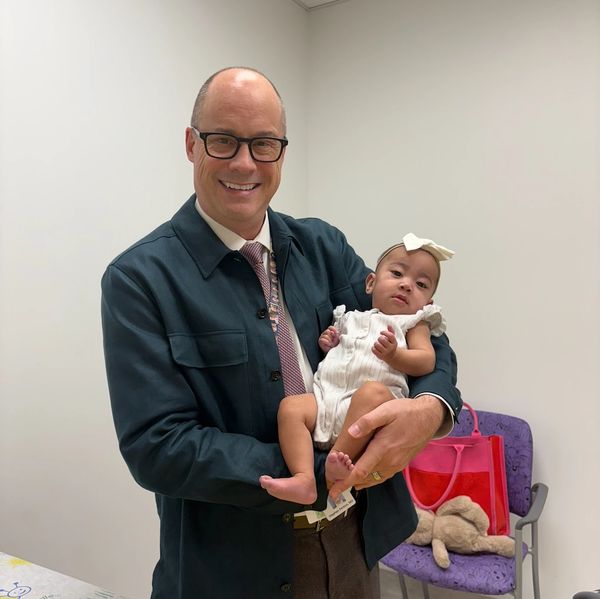 Dr. Fenton holding a baby who had gastroschisis and underwent care at Primary Childrens Hospital.