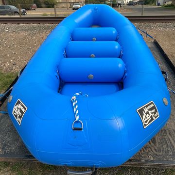 Blue inflatable raft on a trailer.