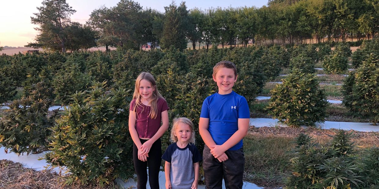 Jake and Lea's kids pose in front of hemp field