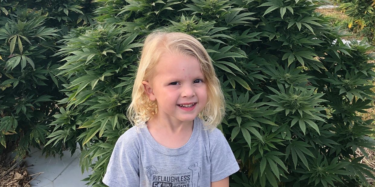 Picture of Wesley in front of a hemp plant