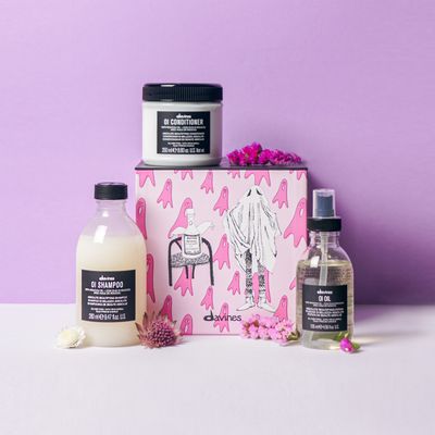 Three hair products and a pink gift box