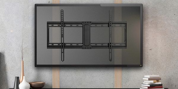 TV bracket mounted on a wall with decorative items below.