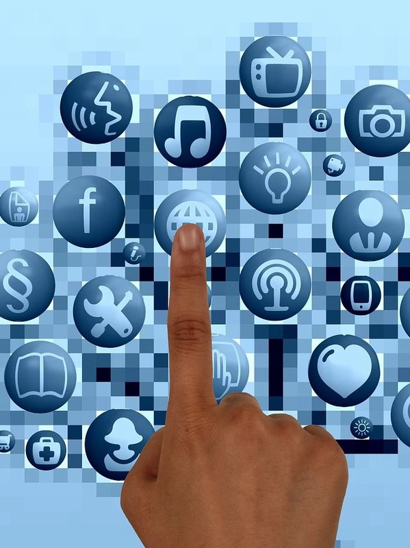 Person pointing on a social media icon on a display