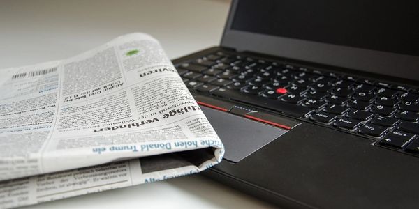 Folded newspaper over a laptop keyboard