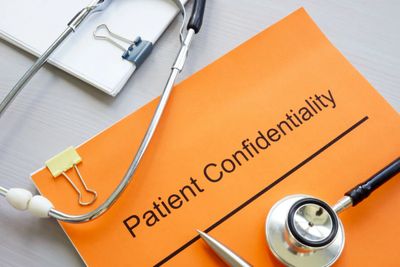 Orange folder labeled 'Patient Confidentiality' with a stethoscope and clipboard.