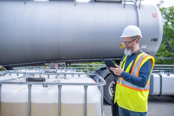 Worker checking oil tanker equipment.