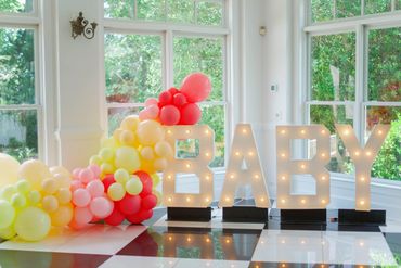 Large "Baby" Letters with pink and yellow balloons.