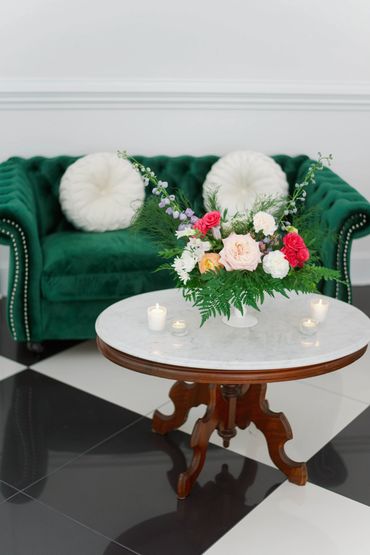 Dark Green couch and coffee table set up for baby shower.
