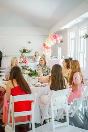 Baby shower guests sitting at tables in the Ballroom.