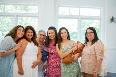 Baby shower guests posing together.