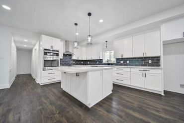 Large kitchen with custom cabinetry, high quality quartz countertops and oversized island