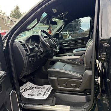 Close-up of a sleek automatic car gear shift and control dial in a modern vehicle.
