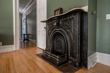 One of two original painted limestone fireplaces