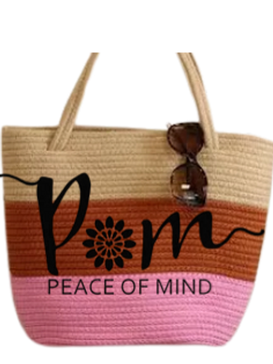 Peace of mind multicoloured handbag with sunglasses hanging down from the top.
