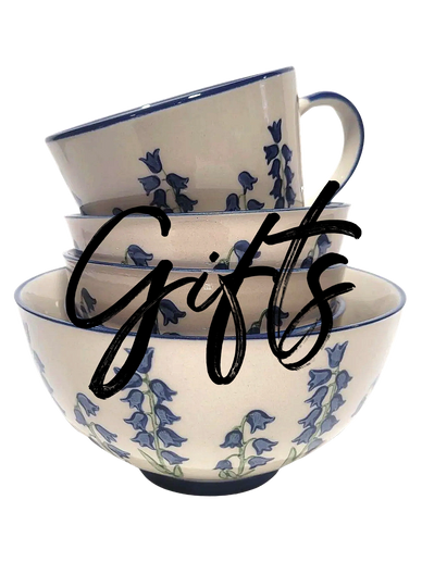 a stack of mug and bowls in an off white with blue and green painted bluebells, white background