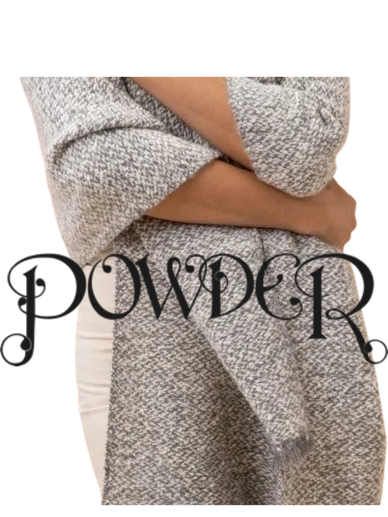 Woman wearing grey powder scarf and white jeans with arms crossed facing the camera