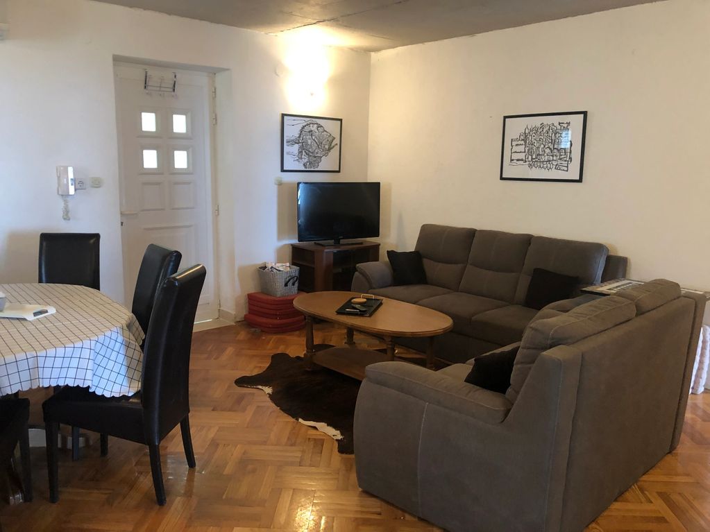living and dining room with grey couches