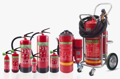 A lineup of various sizes and types of red fire extinguishers against a white background.