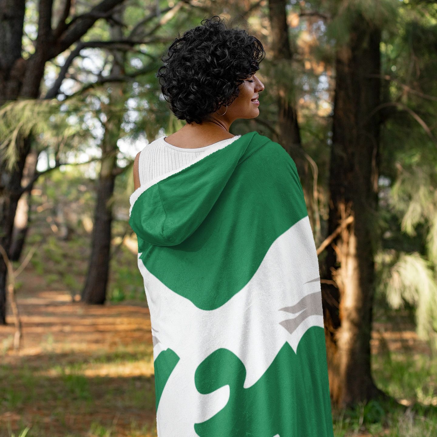 woman wearing a retro kelly green philadelphia eagles hooded blanket outdoors