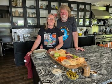 charcuterie board and owners at Rockwynn Lodge