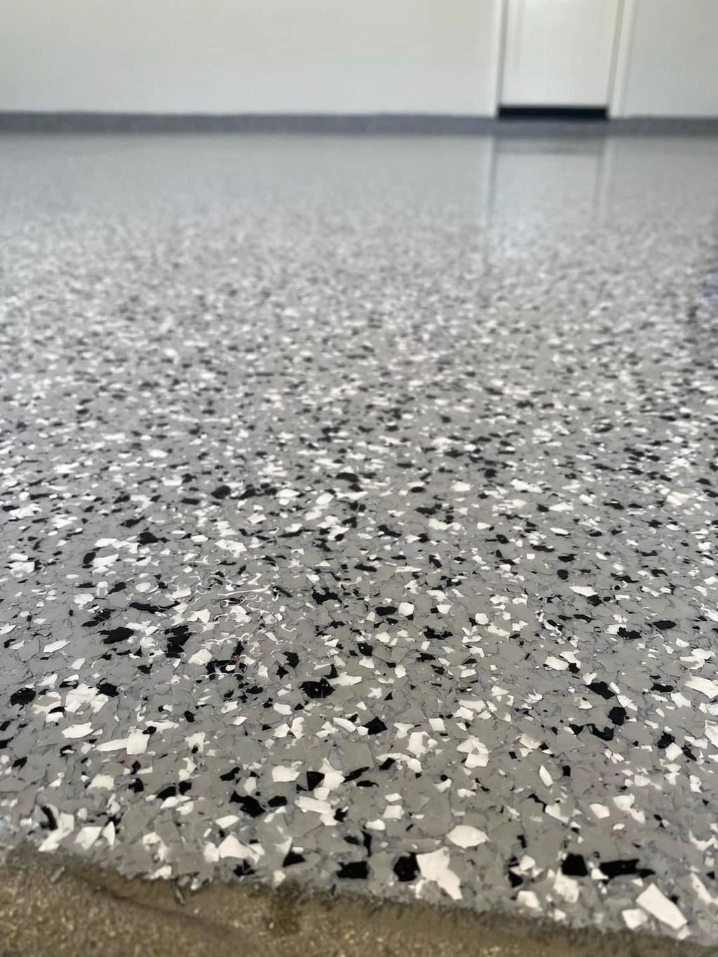 A newly coated epoxy garage floor with decorative flakes.