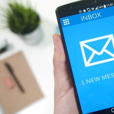 Photo of smart phone with email app on screen.