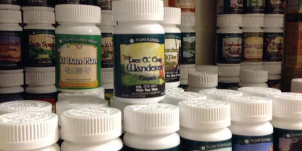 Close-up of shelf full of bottles of herbal formulas.
