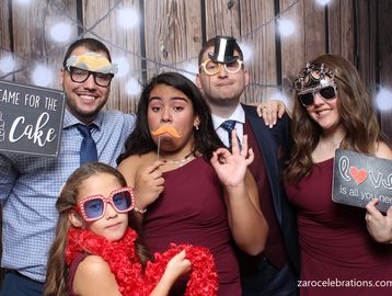 A couple's family having fun in our wedding reception photo booth rental setup.