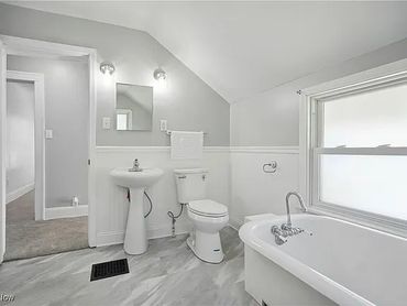 Bathroom remodel with claw foot tub and shower, LVP flooring installation, painting, and plumbing.