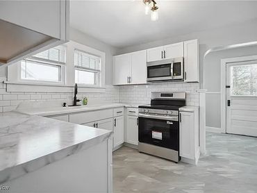 Kitchen addition, painting, lighting, tile work, and new flooring.