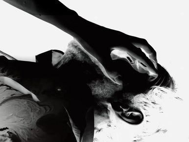 High-contrast black and white image of a person with hand on face, appearing distressed.