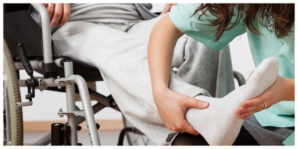 A nurse massaging a patient leg