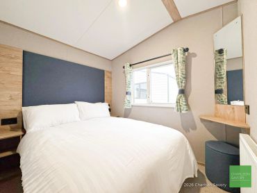 Cozy bedroom with large bed and window.