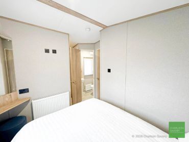 Simple bedroom with open door to bathroom.